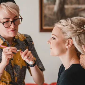 Our make-up artist loading a lip brush from a lipstick palette