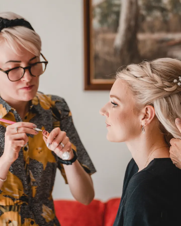 Our make-up artist loading a lip brush from a lipstick palette