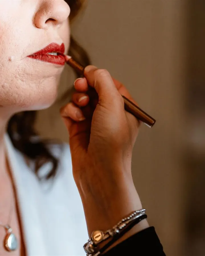 Close-up of lip liner defining a classic red lip